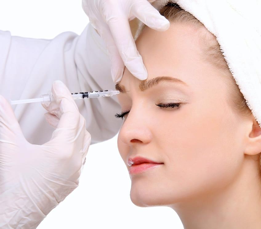 picture of young woman receiving botox treatment in forehead