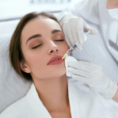 picture of a young woman receiving a perfect pout procedure, woman having lip filler treatments